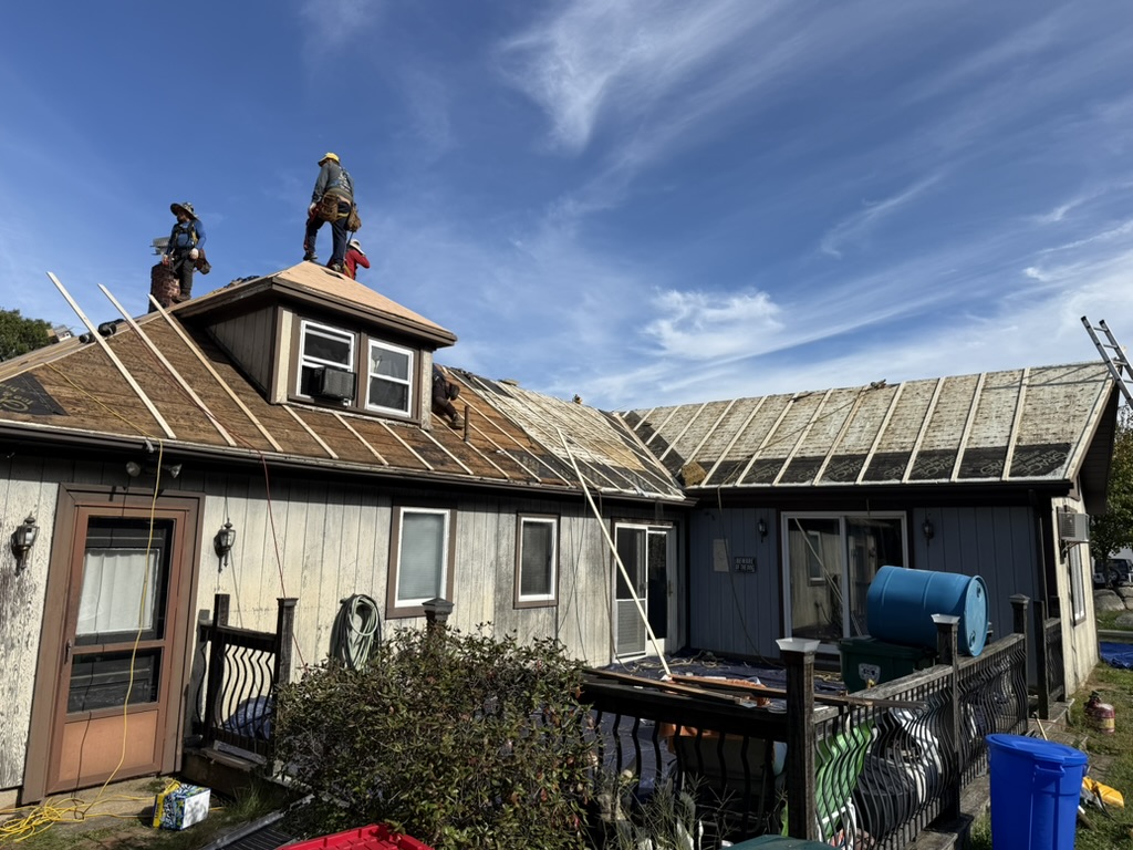 Roof tear-off with dormer and crew working