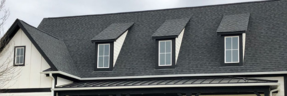 Roofing help image showing a house with asphalt shingles